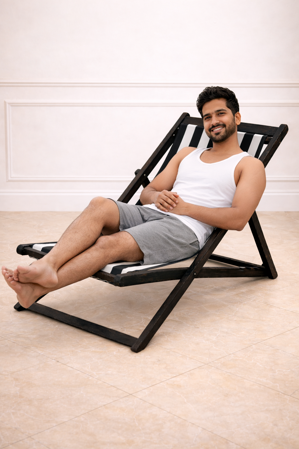 Man sitting on a black lounge chair indoors