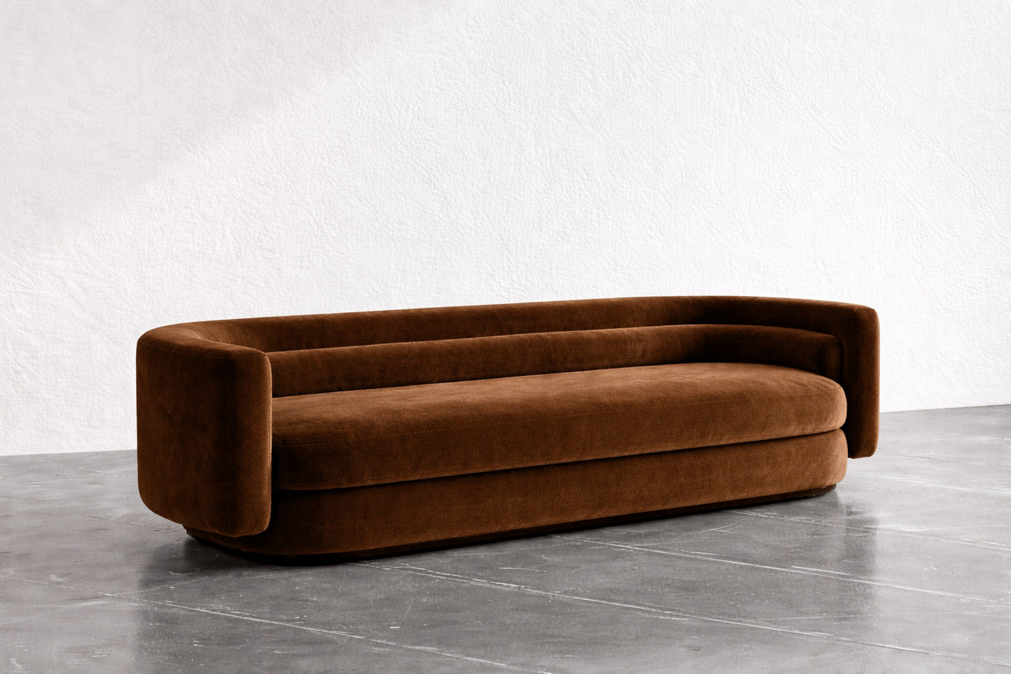 Brown sofa on a gray floor with a white wall background