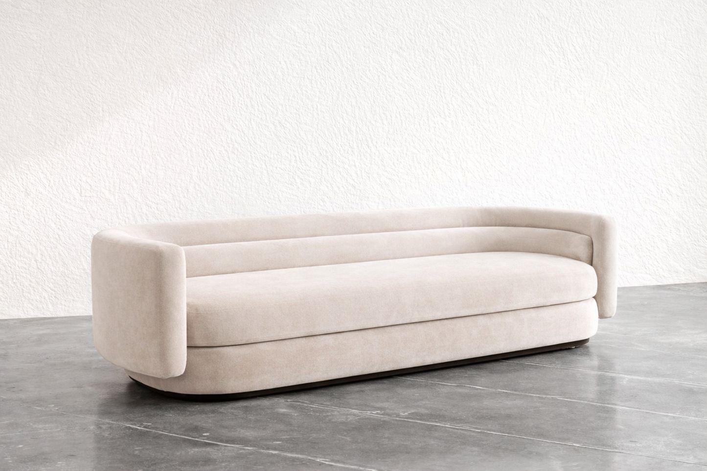 Beige sofa on a gray floor with a white wall background